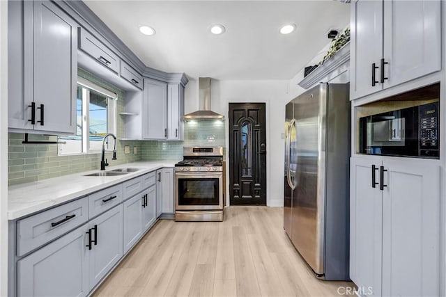 210 Amabel St, Los Angeles, CA 90065 - kitchen with wall chimney range hood, appliances with stainless steel finishes, light wood-style floors, tasteful backsplash, and recessed lighting