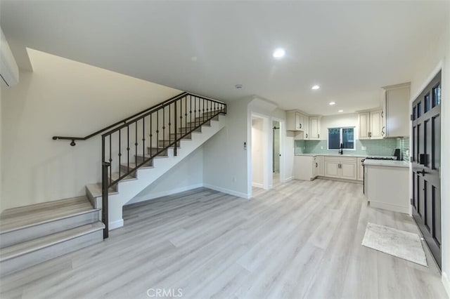 210 Amabel St, Los Angeles, CA 90065 - kitchen with light countertops, light wood-type flooring, recessed lighting, and decorative backsplash
