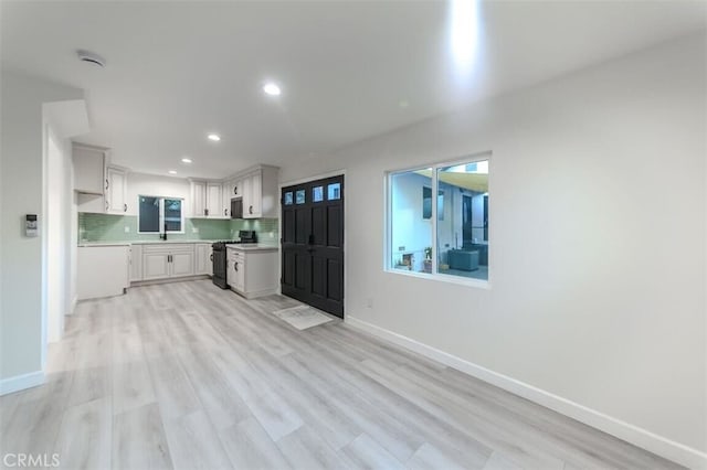 210 Amabel St, Los Angeles, CA 90065 - kitchen with stove, recessed lighting, light countertops, light wood-style floors, and decorative backsplash
