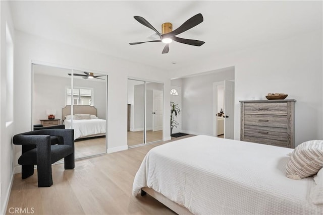 8115 Etiwanda Ave, Reseda, CA 91335 - bedroom featuring two closets, light wood finished floors, baseboards, and ceiling fan