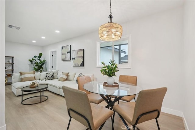 8115 Etiwanda Ave, Reseda, CA 91335 - dining room with light wood finished floors, a chandelier, recessed lighting, and baseboards
