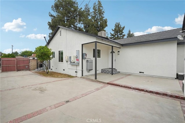 8115 Etiwanda Ave, Reseda, CA 91335 - back of house featuring crawl space, a gate, stucco siding, a patio, and roof with shingles