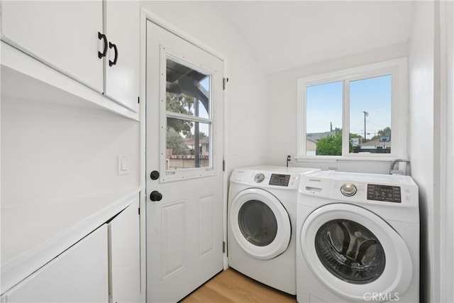 8115 Etiwanda Ave, Reseda, CA 91335 - laundry area with cabinet space, washing machine and clothes dryer, and light wood-style flooring