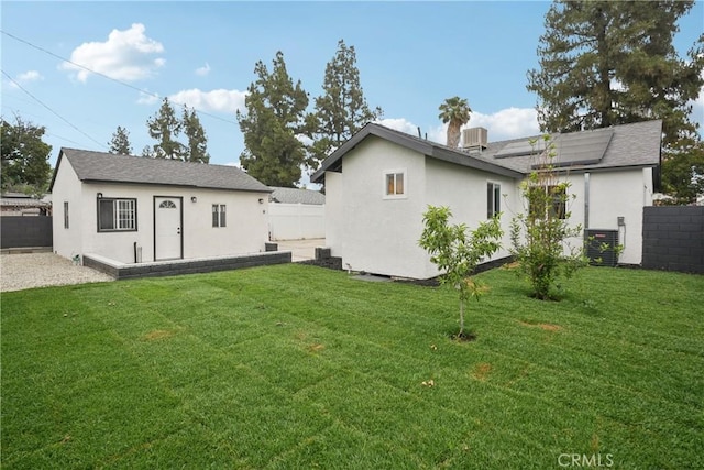 8115 Etiwanda Ave, Reseda, CA 91335 - back of property featuring an outbuilding, solar panels, stucco siding, and cooling unit