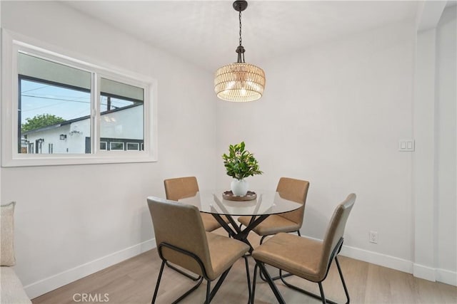 8115 Etiwanda Ave, Reseda, CA 91335 - dining area featuring baseboards, a chandelier, and light wood-style flooring