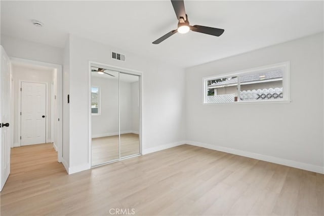 8115 Etiwanda Ave, Reseda, CA 91335 - unfurnished bedroom with light wood finished floors, multiple windows, and a closet