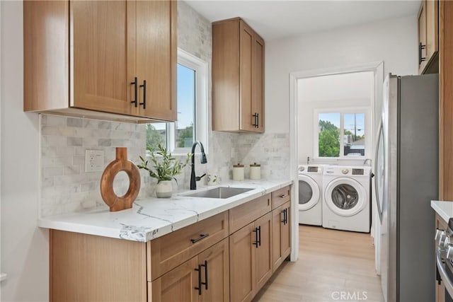 8115 Etiwanda Ave, Reseda, CA 91335 - laundry room featuring separate washer and dryer and light wood-type flooring