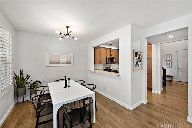 9 Reese Crk, Ladera Ranch, CA 92694 - dining space featuring a chandelier, light wood-type flooring, and baseboards