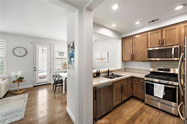 9 Reese Crk, Ladera Ranch, CA 92694 - kitchen featuring appliances with stainless steel finishes, a sink, healthy amount of natural light, hardwood / wood-style flooring, and recessed lighting