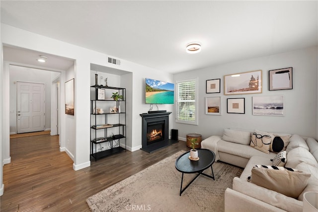 9 Reese Crk, Ladera Ranch, CA 92694 - living area with wood finished floors, a lit fireplace, and baseboards
