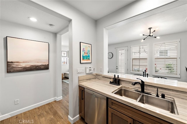 9 Reese Crk, Ladera Ranch, CA 92694 - kitchen with stainless steel dishwasher, a sink, light wood-style flooring, baseboards, and light countertops