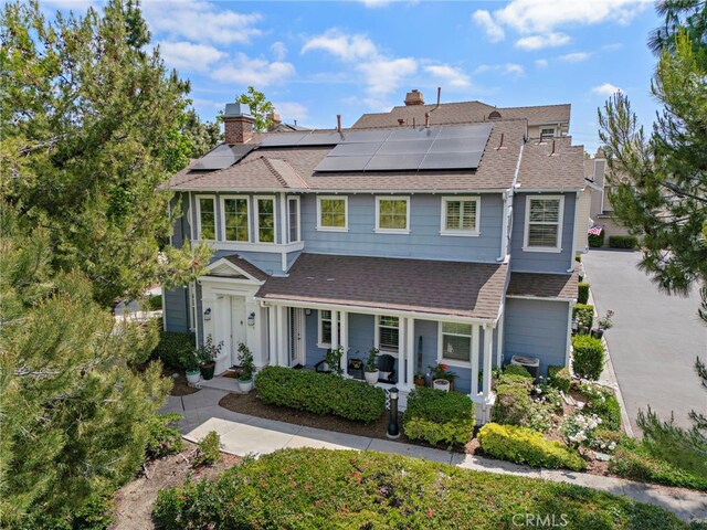 9 Reese Crk, Ladera Ranch, CA 92694 - view of front facade with covered porch, a shingled roof, a chimney, and solar panels