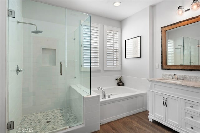 9 Reese Crk, Ladera Ranch, CA 92694 - bathroom featuring a bath, vanity, a stall shower, and wood finished floors