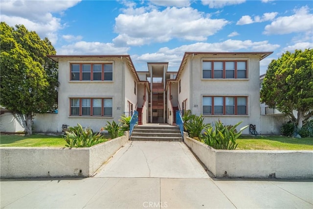 823 W 25th St, San Pedro, CA 90731 - view of front facade with stairway, stucco siding, and a front yard