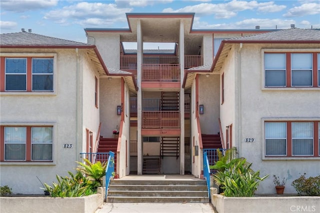 823 W 25th St, San Pedro, CA 90731 - view of front of house with stairs, stucco siding, and a balcony