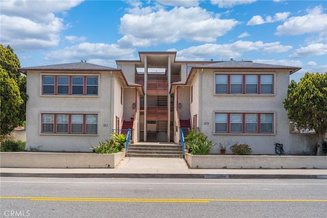 823 W 25th St, San Pedro, CA 90731 - view of front facade featuring stucco siding, stairway, and a balcony