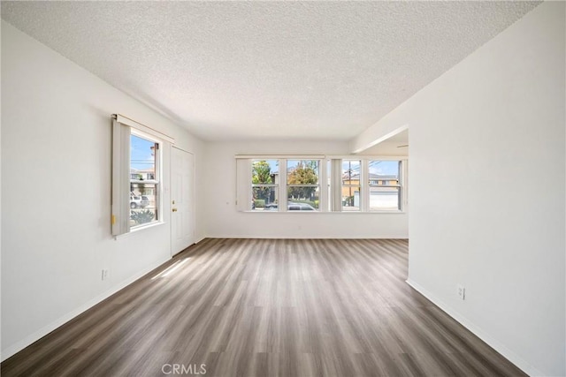 823 W 25th St, San Pedro, CA 90731 - spare room featuring a textured ceiling, wood finished floors, and baseboards
