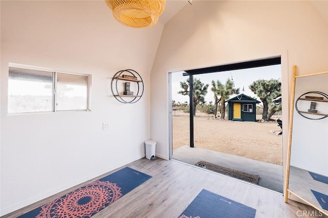 58250 Sierra Vista Dr, Yucca Valley, CA 92284 - doorway featuring wood finished floors, healthy amount of natural light, high vaulted ceiling, and baseboards