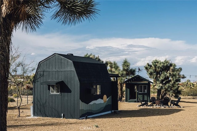 58250 Sierra Vista Dr, Yucca Valley, CA 92284 - view of shed featuring an outdoor fire pit