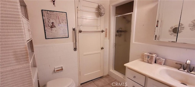 1623 S Sycamore Ave, Los Angeles, CA 90019 - bathroom with vanity, a shower stall, tile patterned flooring, tile walls, and a wainscoted wall