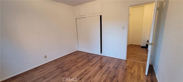1623 S Sycamore Ave, Los Angeles, CA 90019 - unfurnished bedroom with wood finished floors and a closet