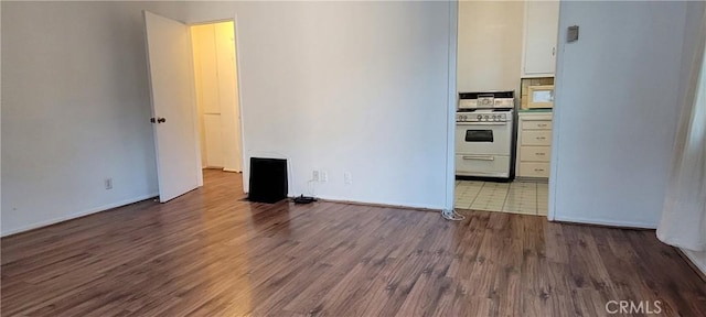 1623 S Sycamore Ave, Los Angeles, CA 90019 - spare room featuring wood finished floors and baseboards