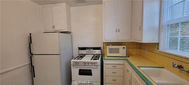 1623 S Sycamore Ave, Los Angeles, CA 90019 - kitchen featuring white appliances, white cabinets, and decorative backsplash