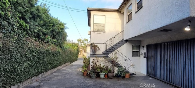 1623 S Sycamore Ave, Los Angeles, CA 90019 - view of side of property with stucco siding and stairs