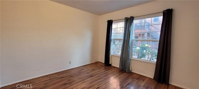1623 S Sycamore Ave, Los Angeles, CA 90019 - empty room featuring wood finished floors and baseboards