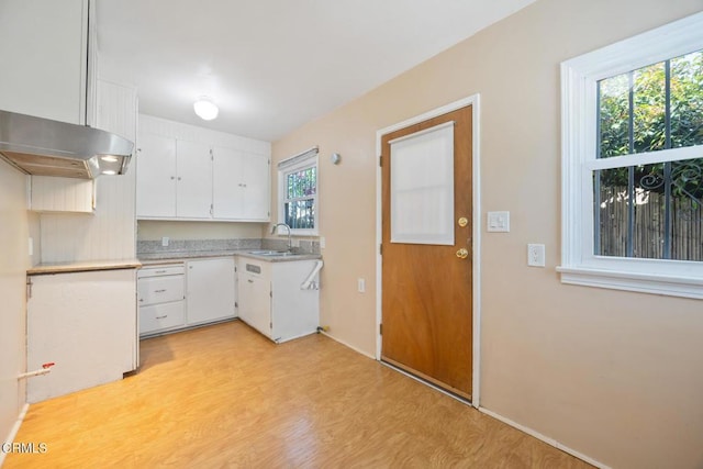  - kitchen featuring white cabinets, light countertops, and light wood-type flooring