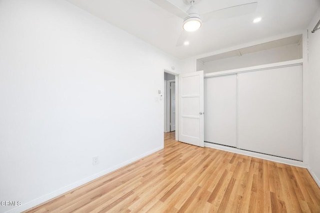  - unfurnished bedroom with wood finished floors, a closet, ceiling fan, and recessed lighting