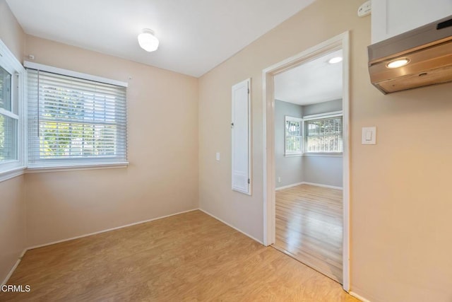  - empty room featuring light wood-style flooring and a smoke detector