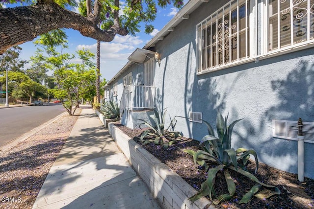  - view of side of home featuring stucco siding