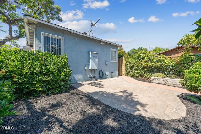  - back of property featuring stucco siding and a patio area