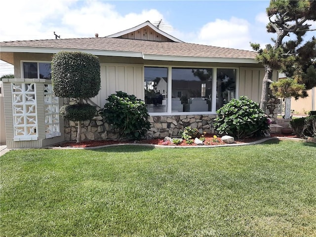 9864 Van Ruiten St, Bellflower, CA 90706 - rear view of house with board and batten siding, a yard, and a shingled roof