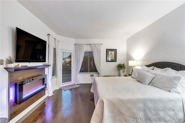 3 Nice Unit 25, Laguna Niguel, CA 92677 - bedroom with a glass covered fireplace, hardwood / wood-style flooring, access to outside, and baseboards