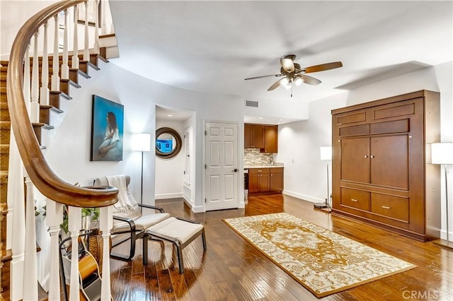 3 Nice Unit 25, Laguna Niguel, CA 92677 - sitting room with stairs, a ceiling fan, baseboards, and dark wood-style flooring