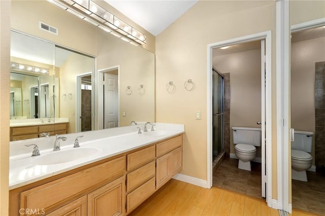 28462 La Alcala, Laguna Niguel, CA 92677 - full bathroom featuring double vanity, wood finished floors, a stall shower, and vaulted ceiling