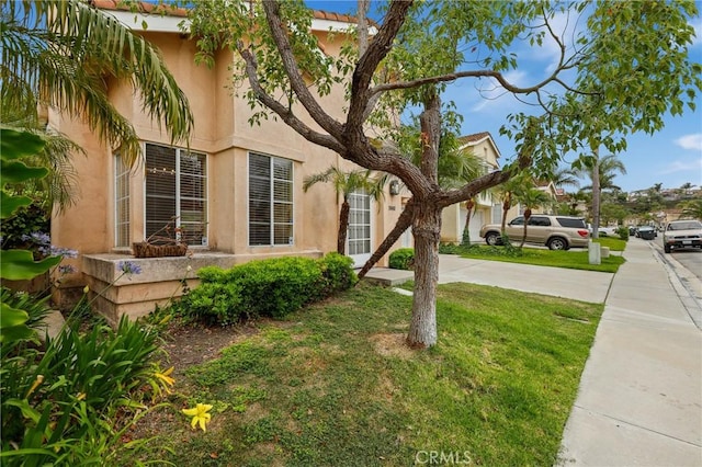 28462 La Alcala, Laguna Niguel, CA 92677 - view of front of house featuring stucco siding, a front yard, and driveway