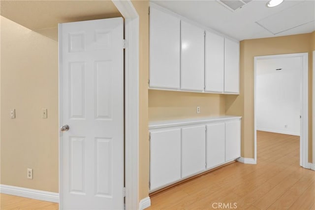 28462 La Alcala, Laguna Niguel, CA 92677 - kitchen featuring white cabinets, light wood finished floors, and light countertops
