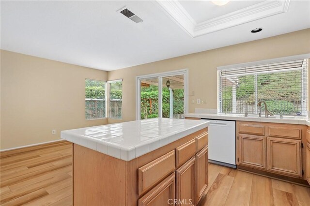 28462 La Alcala, Laguna Niguel, CA 92677 - kitchen featuring dishwasher, tile counters, light wood finished floors, a center island, and a tray ceiling