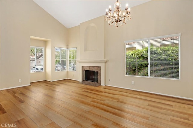 28462 La Alcala, Laguna Niguel, CA 92677 - unfurnished living room with high vaulted ceiling, wood finished floors, a premium fireplace, and a chandelier