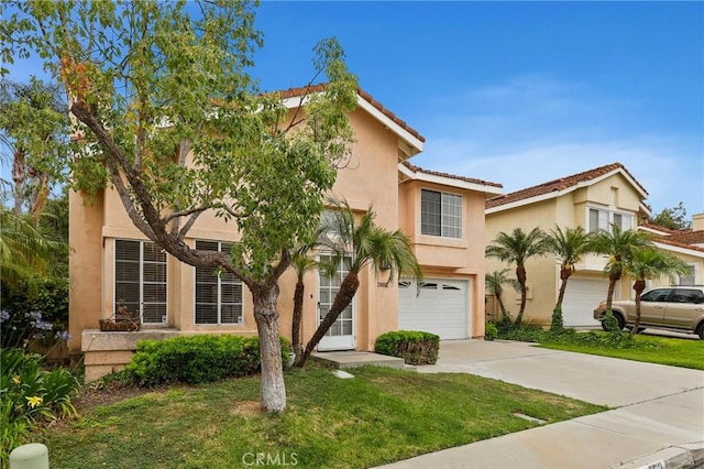28462 La Alcala, Laguna Niguel, CA 92677 - view of front of home with a garage, stucco siding, driveway, and a front lawn