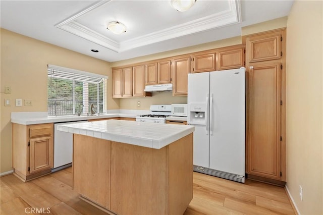 28462 La Alcala, Laguna Niguel, CA 92677 - kitchen featuring white appliances, under cabinet range hood, tile counters, a raised ceiling, and a kitchen island