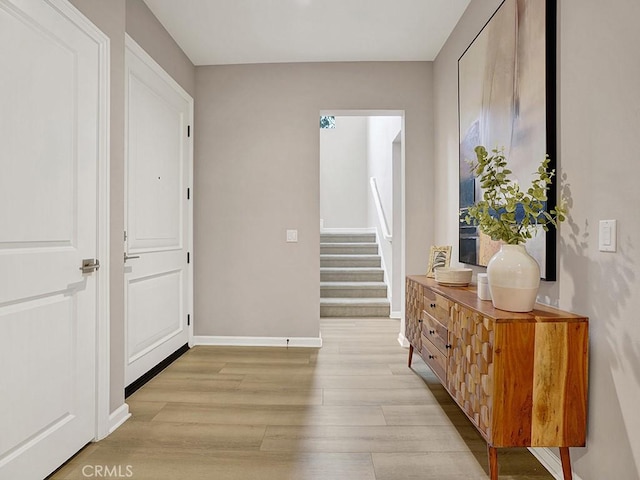 159 Frazier, Irvine, CA 92620 - hallway featuring light wood finished floors, stairs, and baseboards