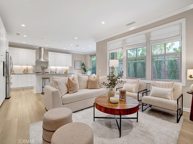 159 Frazier, Irvine, CA 92620 - living area featuring healthy amount of natural light, light wood-type flooring, recessed lighting, and crown molding