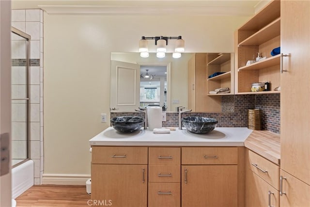 1377 Knoll Rd, Redlands, CA 92373 - full bathroom with crown molding, decorative backsplash, vanity, combined bath / shower with glass door, and wood finished floors