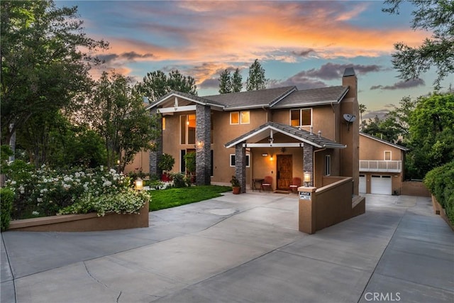 1377 Knoll Rd, Redlands, CA 92373 - view of front of home with a chimney, concrete driveway, stucco siding, stone siding, and a garage