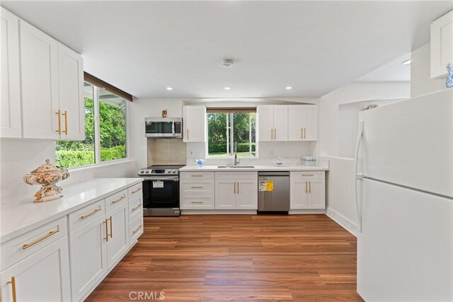 1377 Knoll Rd, Redlands, CA 92373 - kitchen with appliances with stainless steel finishes, healthy amount of natural light, light wood-style flooring, white cabinetry, and recessed lighting