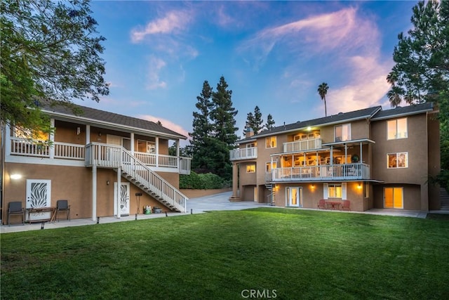 1377 Knoll Rd, Redlands, CA 92373 - back of house with stucco siding, stairs, a patio, and a yard